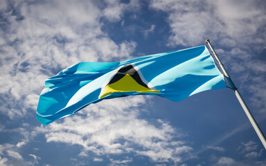 National state flag of Santa Lucia fluttering at sky background.