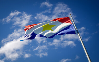 National state flag of Saba fluttering at sky background.