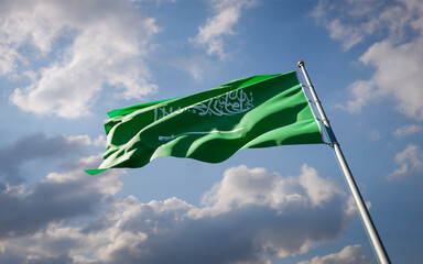 National state flag of Saudi Arabia fluttering at sky background.