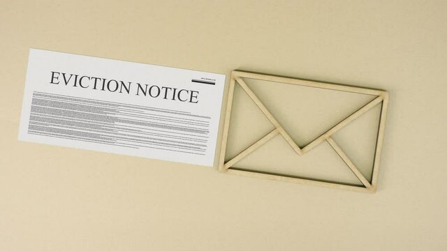 Eviction notice and the envelope icon on cardboard background