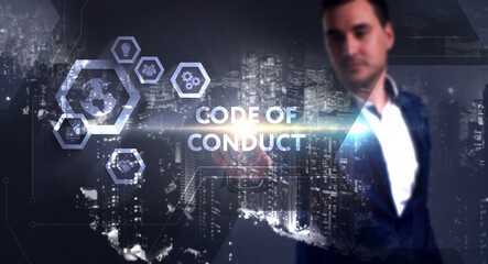 Business, Technology, Internet and network concept. Young businessman working on a virtual screen of the future and sees the inscription: Code of conduct
