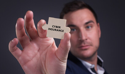 Business, Technology, Internet and network concept. Young businessman shows the word: Cyber insurance