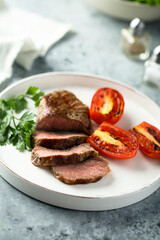 Beef steak with grilled tomatoes and parsley