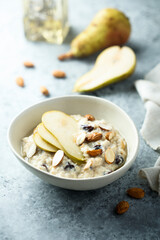 Oatmeal porridge with nuts, raisins and fresh pear