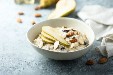 Oatmeal porridge with nuts, raisins and fresh pear