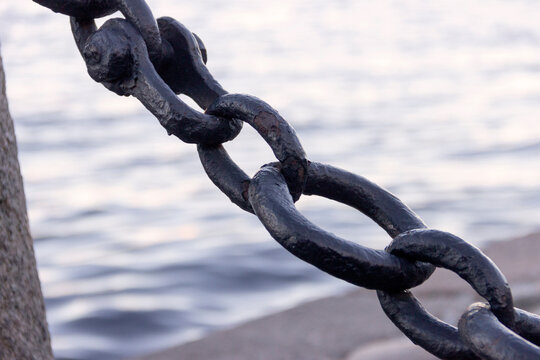 An old wrought iron chain on the embankment of the Neva River in St. Petersburg.