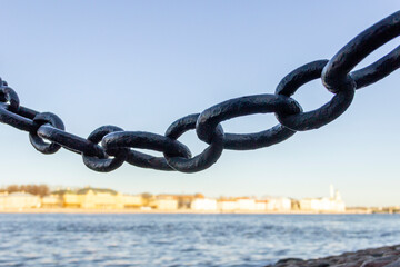 An old wrought iron chain on the embankment of the Neva River in St. Petersburg.