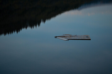 Closeup of a wooden raft on a smooth water surface