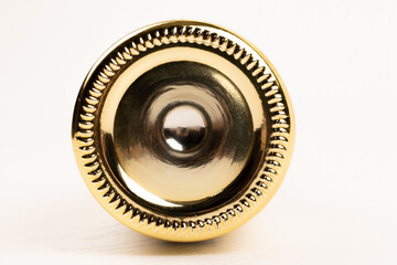 bottom of festive golden bottle of champagne on white wooden table background close up