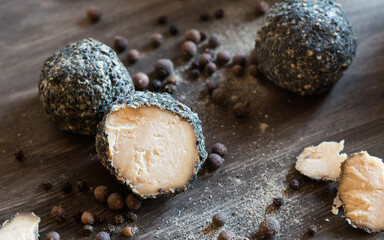 Swiss cheese Belper Knolle in the shape of small balls sprinkled with black pepper. Gourmet...