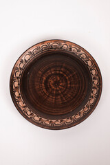 Ceramic ware isolated on a white background. Single rustic clay plate. 
