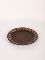 Ceramic ware isolated on a white background. Single rustic clay plate. 