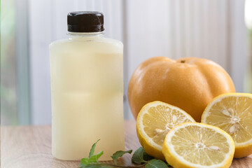 Freshly summer fruit and berries cold press juice serve in grass bottle in ther morning nature background.