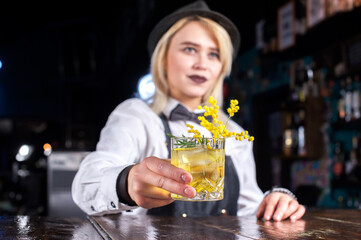 Girl bartender concocts a cocktail in the taproom
