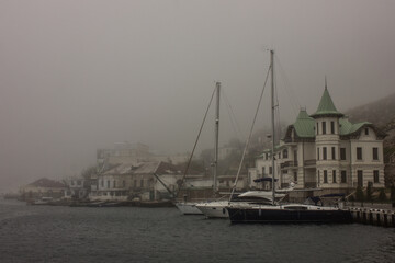 Republic of Crimea, city of Balaklava 07/14/2020: Sea port of the bay on a foggy morning.