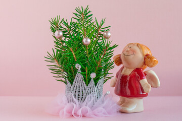 new year's composition of green fir branches on a pink background