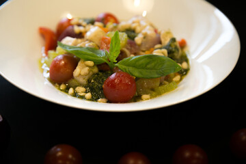 Italian stewed vegetables with cherry tomatoes and pine nuts

