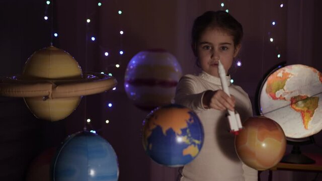 Space Travel Spaceship. Creative Little Girl Astronaut Launching Rocket From Spaceport Through Planets. Child Dreamer Playing Space Rocket Flying Among Planets. Spaceman Fantasy Flying on Spacecraft.