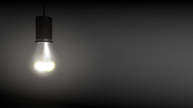 4k video of light bulb on grey background.