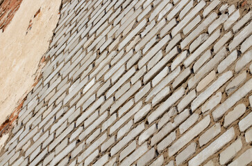White brick wall close-up, texture with perspective.