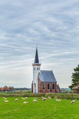 Fototapeta na wymiar Picturesque churh Den Hoorn in rural areas of the Wadden sialnd Texel in North Holland, The Netherlands