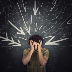 Disappointed guy covers face with his hands, looking down introverted and depressed, being under...