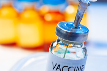 Medical vial with medication and syringe close up