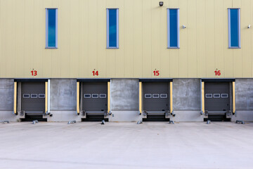 Row of loading docks with shutter doors at an industrial warehouse.