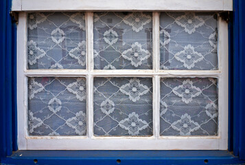 Colonial window and lace curtain in Tiradentes, Brazil 