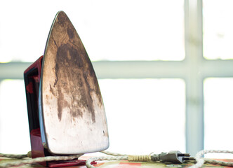 Floor iron teflon iron, household equipment dirty scorched from heat damage to clothes or housework...