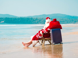 Santa Claus on a journey by the sea on a hot day