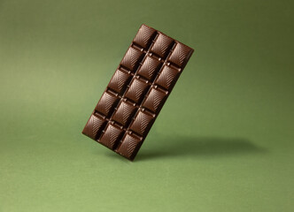 chocolate bar on green color background