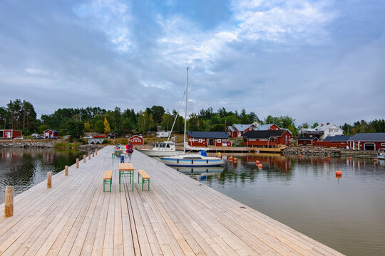  a large wooden pier and a beautiful view of the yachts, town and island of Lappo located on the Aland islands in Finland. view from the pier, landscape.