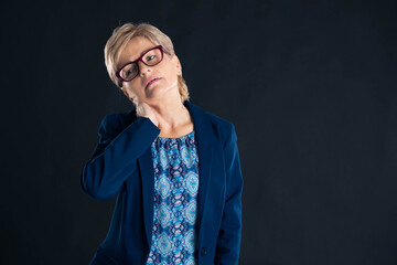 Portrait of an older businesswoman having neck pain