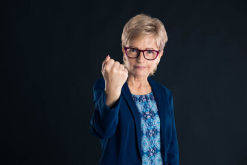 Older businesswoman showing you the fist