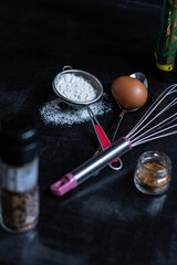 set for the dough, the dough from flour, dishes with dough products on a black background