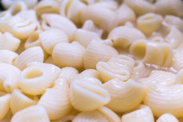 close up of pasta shells with broth