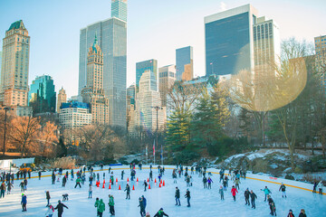 Ice skaters having fun in New York Central Park in winter
