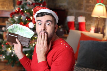 Happy man with lots of money during Christmas