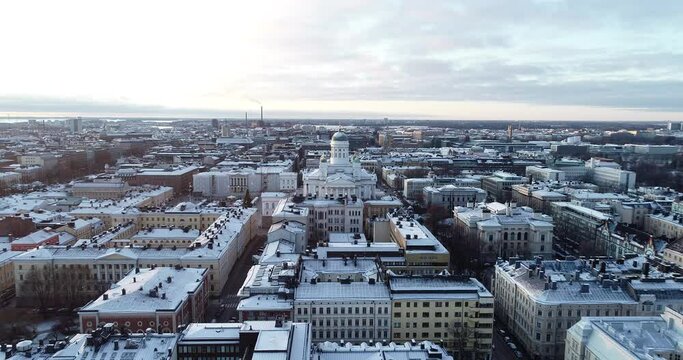 Aerial Drone View Helsinki Cathedral at sunset. Winter season. Festive street with Christmas decorations. Senate squar.