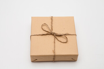 Brown parcel Kraft gift box present on white background