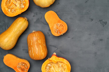 Pile of pumpkins on dark background top view