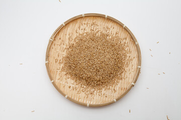 Oats in a bamboo dish on white background