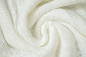 Background of woolen knitted white warm sweater from above