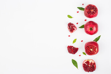 Pomegranate in composition in studio on white background