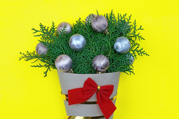 Christmas theme with a bouquet of thuja twigs and a red bow. Green twigs in a bouquet package. New...