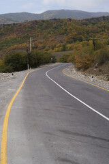 Hilly country road line, close-up. Empty asphalt road