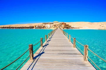 Foto op Canvas Wooden Pier at Orange Bay Beach with crystal clear azure water and white beach - paradise coastline of Giftun island, Mahmya, Hurghada, Red Sea, Egypt. © Simon Dannhauer
