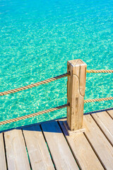 Background of wooden deck and blue water - tropical scenery in paradise travel destination