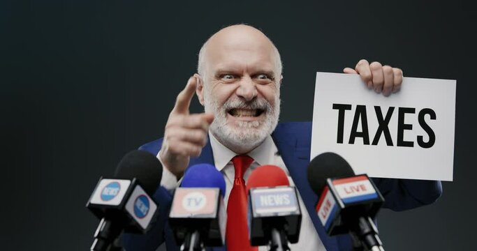 Aggressive politician holding a sign with taxes concept